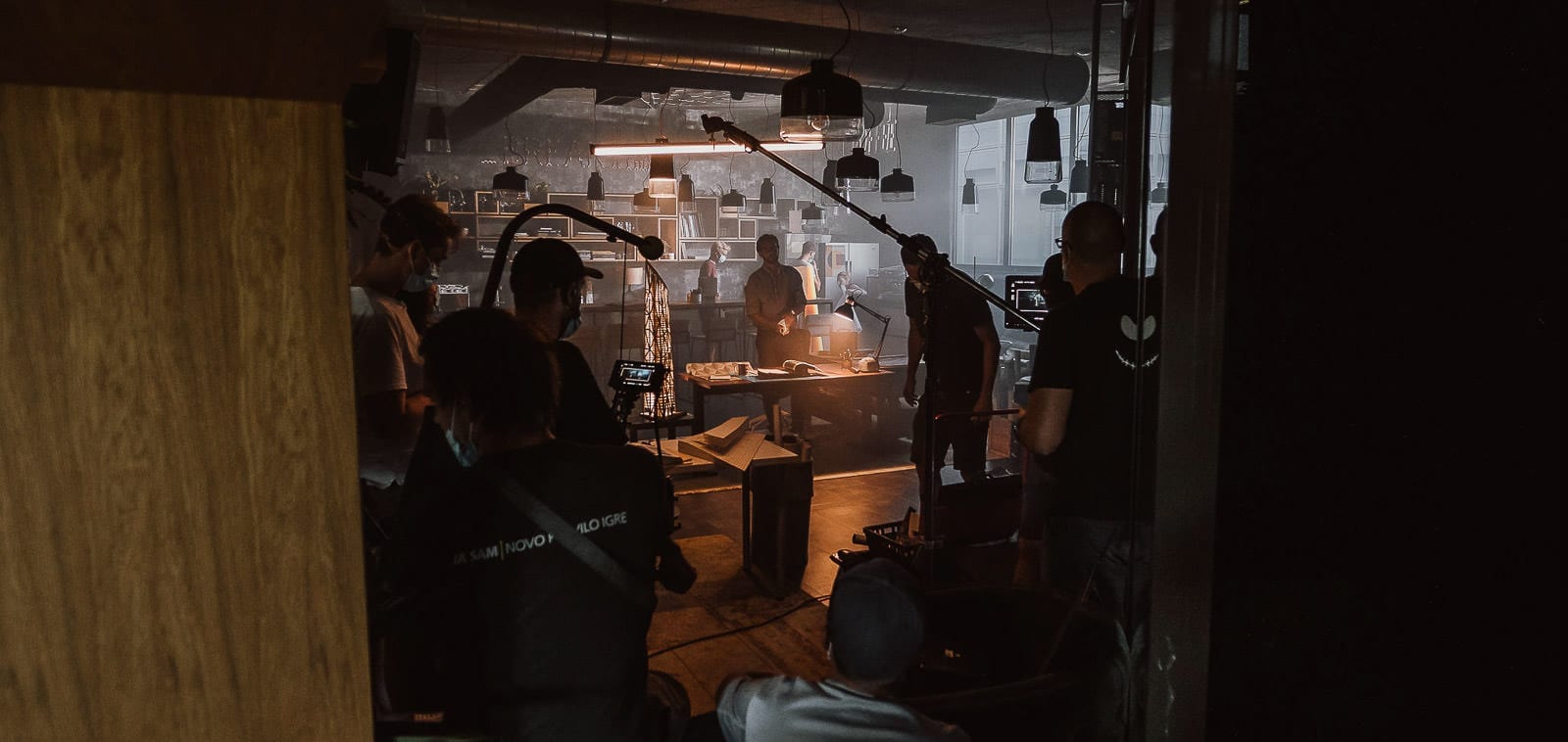 Squareme Triglav Skladi TV ads - production crew during filming in a moody lit office space